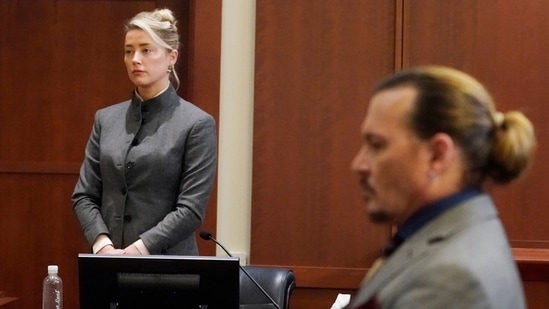 Actors Amber Heard and Johnny Depp watch as the jury leaves the courtroom at a court in the US.(AP)