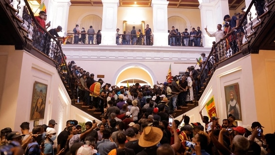 Demonstrators protest inside the President's House, after President Gotabaya Rajapaksa fled, amid the country's economic crisis, in Colombo,