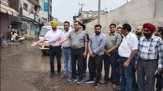 Industrialists showing the pathetic condition of potholed road in Ludhiana. (Harvinder Singh/HT)