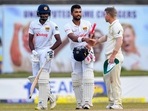 Dinesh Chandimal (c) and Ramesh Mendis (L) with David Warner(AFP) Dinesh Chandimal (c) and Ramesh Mendis (L) with David Warner(AFP)