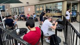 People crowd around a coffee shop in Toronto, Ontario to use its free wifi on the Bell network, during a major outage of Rogers Communications' mobile and internet networks which caused widespread disruptions across Canada on Friday. (REUTERS)