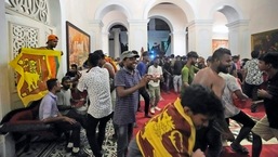 Protesters sing and dance after storming in at the Sri Lankan president official residence, in Colombo, Sri Lanka. 