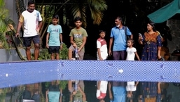 People stand by the swimming pool of the presidential palace a day after demonstrators entered the building as Colombo President Gotabaya Rajapaksa fled due to the country's economic crisis.