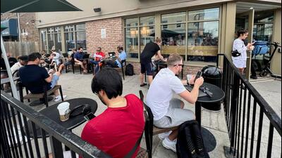 People crowd around a coffee shop in Toronto, Ontario to use its free wifi on the Bell network, during a major outage of Rogers Communications' mobile and internet networks which caused widespread disruptions across Canada on Friday. (REUTERS) People crowd around a coffee shop in Toronto, Ontario to use its free wifi on the Bell network, during a major outage of Rogers Communications' mobile and internet networks which caused widespread disruptions across Canada on Friday. (REUTERS)