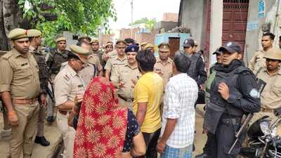 SSP Aligarh Kalanidhi Naithani (in blue cap) pacifying villagers in Musepur village on Sunday. (HT PHOTO) SSP Aligarh Kalanidhi Naithani (in blue cap) pacifying villagers in Musepur village on Sunday. (HT PHOTO)