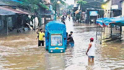 People push a vehicle through a flooded area near Purna river following heavy rainfall, in Gujarat’s Navsari on Sunday. (ANI) People push a vehicle through a flooded area near Purna river following heavy rainfall, in Gujarat’s Navsari on Sunday. (ANI)