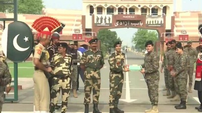 BSF (Border Security Force) and Pakistan Rangers exchange sweets at Attari-Wagah border on the occasion of the festival. (ANI)