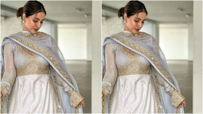Hina teamed her salwar with a pastel grey flowy long skirt with golden prints and white and gold zari details at the ankles. Hina added more festive vibes to her look with a pastel grey dupatta featuring gold zari at the borders. (Instagram/@realhinakhan)