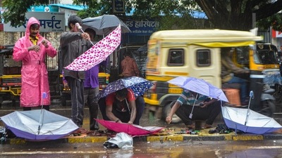 Workers repair umbrellas on a rainy day in Karad on Saturday, (PTI) Workers repair umbrellas on a rainy day in Karad on Saturday, (PTI)