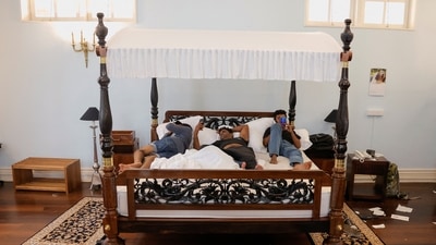 Demonstrators sleep on President Gotabaya Rajapaksa's bed at the President's house, on the following day after demonstrators entered the building in Colombo, Sri Lanka.&nbsp; (REUTERS)