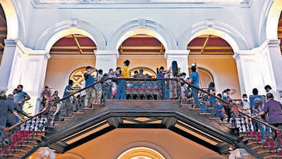 People crowd inside the Sri Lanka's presidential palace in Colombo on Sunday. (AFP) People crowd inside the Sri Lanka's presidential palace in Colombo on Sunday. (AFP)