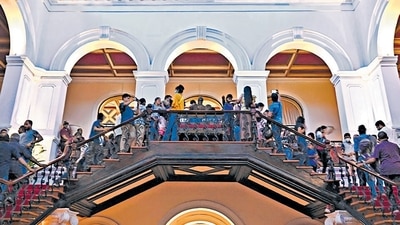 People crowd inside the Sri Lanka's presidential palace in Colombo on Sunday. (AFP)