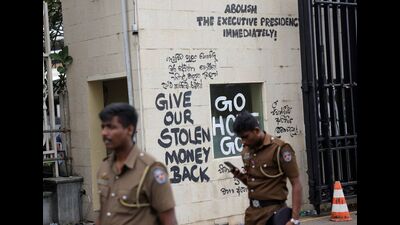 Police officers walk past a slogan written on the walls of a security room near the President's house on the following day after demonstrators entered the building, after President Gotabaya Rajapaksa fled, amid the country's economic crisis, in Colombo, Sri Lanka July 10, 202 (REUTERS) Police officers walk past a slogan written on the walls of a security room near the President's house on the following day after demonstrators entered the building, after President Gotabaya Rajapaksa fled, amid the country's economic crisis, in Colombo, Sri Lanka July 10, 202 (REUTERS)
