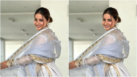 Hina decked up in a pastel grey and white salwar that came heavily embroidered in golden zari details. The salwar also featured tassel details at the knees and a plunging neckline.(Instagram/@realhinakhan)