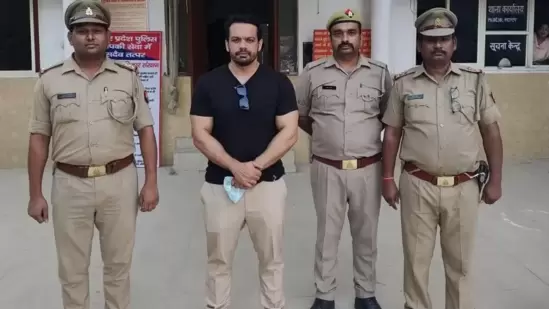 Gaurav Taneja with Noida Police personnel following his arrest.