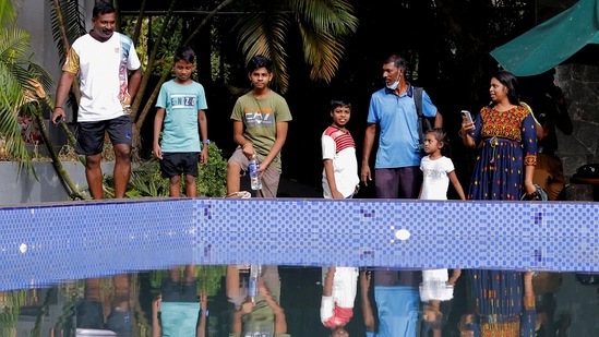People stand by a pool at the President's house on the following day after demonstrators entered the building, after President Gotabaya Rajapaksa fled, amid the country's economic crisis, in Colombo.(Reuters)