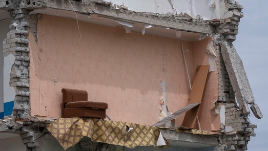 A sofa chair is seen in what is left standing in the aftermath of a Russian rocket that hit an apartment residential block, in Chasiv Yar, Donetsk region, eastern Ukraine.(AP)
