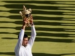Novak Djokovic holds the winners trophy as he celebrates after beating Australia's Nick Kyrgios (AP) Novak Djokovic holds the winners trophy as he celebrates after beating Australia's Nick Kyrgios (AP)