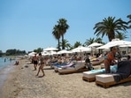 People visit Dassia beach on the island of Corfu, Greece. Greece sees spike in tourists, expects economy growth due to tourism boom&nbsp;