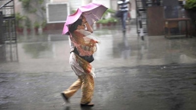 A woman struggles with her umbrella against a strong wind during a sudden heavy downpour in New Delhi. (File image) A woman struggles with her umbrella against a strong wind during a sudden heavy downpour in New Delhi. (File image)