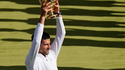 Novak Djokovic holds the winners trophy as he celebrates after beating Australia's Nick Kyrgios (AP) Novak Djokovic holds the winners trophy as he celebrates after beating Australia's Nick Kyrgios (AP)