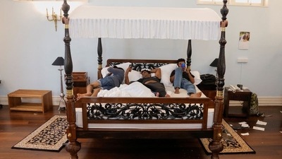 Demonstrators sleep on the President's bed at Gotabaya Rajapaksa's official residence. (REUTERS)