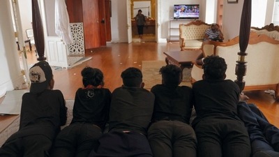 Demonstrators watch TV in one of the bedrooms at the President's house. (REUTERS)