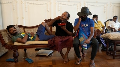 Protesters relax as they spend time in President Gotabaya Rajapaksa's official residence after it was stormed in Colombo, Sri Lanka. (AP) Protesters relax as they spend time in President Gotabaya Rajapaksa's official residence after it was stormed in Colombo, Sri Lanka. (AP)