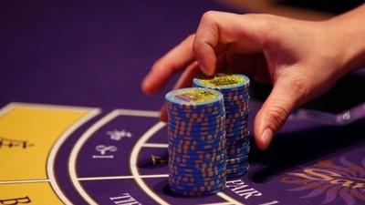 FILE - A croupier counts the chips at a baccarat gaming table inside a casino. (AP)