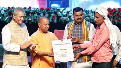 Uttar Pradesh chief minister Yogi Adityanath distributes share certificate to a farmer. (ANI PHOTO) Uttar Pradesh chief minister Yogi Adityanath distributes share certificate to a farmer. (ANI PHOTO)