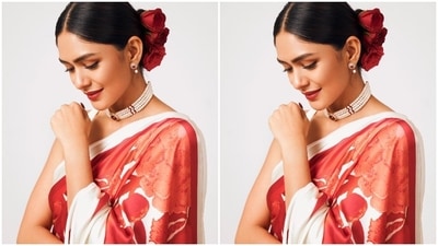 To glam up the look, Mrunal tied her hair in a centre-parted sleek bun adorned with rose hair accessories. She chose a choker necklace - with pearl strands and ruby stone embellishments - matching earrings, and strappy nude-coloured block heels for the accessories. (Instagram) To glam up the look, Mrunal tied her hair in a centre-parted sleek bun adorned with rose hair accessories. She chose a choker necklace - with pearl strands and ruby stone embellishments - matching earrings, and strappy nude-coloured block heels for the accessories. (Instagram)