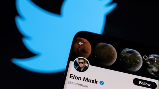 Elon Musk's twitter account is seen on a smartphone in front of the Twitter logo in this photo illustration.(REUTERS)