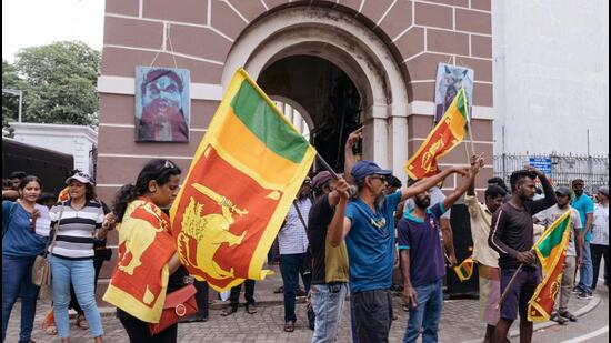 Protesters and ordinary people outside the Presidential Palace in Colombo, Sri Lanka, on Sunday. Sri Lankan President Gotabaya Rajapaksa?will resign on Wednesday after fleeing his official residence shortly before demonstrators stormed it last week. (BLOOMBERG.)