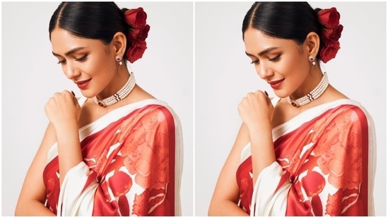 To glam up the look, Mrunal tied her hair in a centre-parted sleek bun adorned with rose hair accessories. She chose a choker necklace - with pearl strands and ruby stone embellishments - matching earrings, and strappy nude-coloured block heels for the accessories.(Instagram)