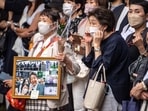 People gather for the hearse carrying late former Japanese prime minister Shinzo Abe leaves Zojoji Temple in Tokyo on July 12, 2022.
