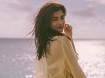 Pooja Hegde in bikini and see-through shirt gets some Vitamin D after taking a dip in the sea(Instagram) Pooja Hegde in bikini and see-through shirt gets some Vitamin D after taking a dip in the sea(Instagram)