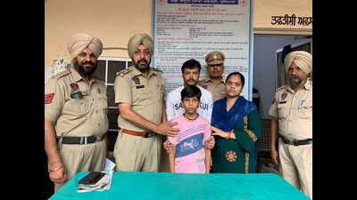 Police handing over the boy to his family in Ludhiana on Tuesday. (HT Photo)