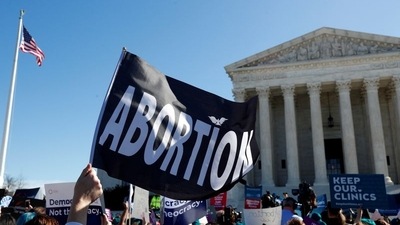 A demonstrator holds up an abortion flag outside of the US Supreme Court on Capitol Hill in Washington. (Reuters)