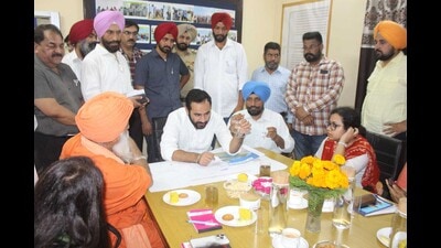 Punjab minister Gurmeet Singh Meet Hayer discussing the Buddha Nullah rejuvenation project with officials in Ludhiana on Tuesday. (HT Photo)