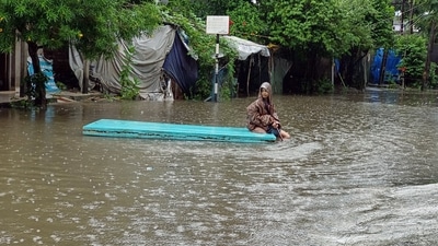 Navsari (Gujarat): A kid amid the waterlogging in Oria Moria residential areas in Bilimora town of Navsari district of Gujarat, on Monday. (Hitesh Vilas) Navsari (Gujarat): A kid amid the waterlogging in Oria Moria residential areas in Bilimora town of Navsari district of Gujarat, on Monday. (Hitesh Vilas)