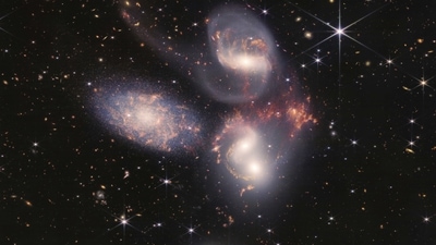 This image shows Stephan's Quintet, a visual grouping of five galaxies captured by the Webb Telescope's Near-Infrared Camera (NIRCam) and Mid-Infrared Instrument (MIRI). (AP) This image shows Stephan's Quintet, a visual grouping of five galaxies captured by the Webb Telescope's Near-Infrared Camera (NIRCam) and Mid-Infrared Instrument (MIRI). (AP)