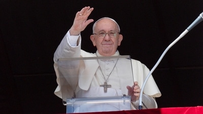 Pope Francis waves as he leads the Angelus prayer from his window, at the Vatican. (via REUTERS)