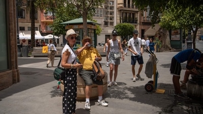 A man drinks water during a heatwave in Seville. Firefighters battled wildfires in Spain and Portugal as Western Europe faced its second heatwave in less than a month which threatened glaciers in the Alps and worsened drought conditions.&nbsp; (AFP)