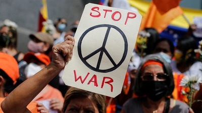 A protestor holds a peace sign during an anti-war protest amid Russia's invasion of Ukraine. (REUTERS)