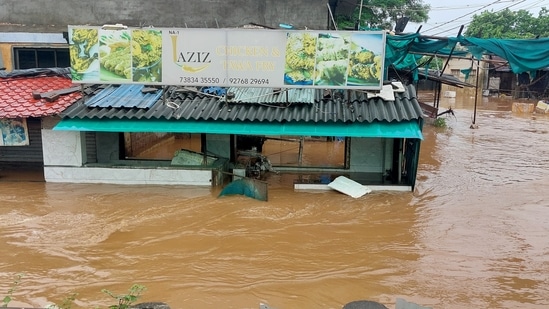 Shops get partially submerged in floodwater following heavy rainfall, in Gujarat's Navsari.( DJ RAJ)