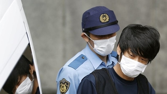 Tetsuya Yamagami - suspected of killing former Japanese Prime Minister Shinzo Abe, is escorted by a police officer. (Credit: Kyodo via REUTERS)