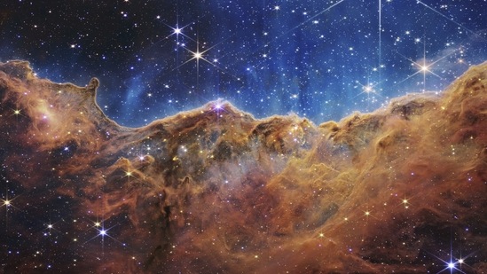 This image shows the edge of a nearby, young, star-forming region NGC 3324 in the Carina Nebula. Captured in infrared light by the Near-Infrared Camera (NIRCam) on the James Webb Space Telescope, this image reveals previously obscured areas of star birth, according to NASA. (AP)