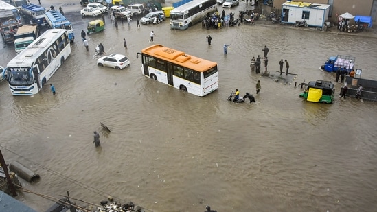 Vehicles wade through the waterlogged Ring Road after monsoon rains, in Rajkot.(PTI)