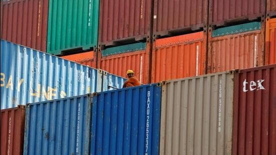 A worker sits on a heap of containers at Mundra port in Gujarat. (REUTERS File Photo)