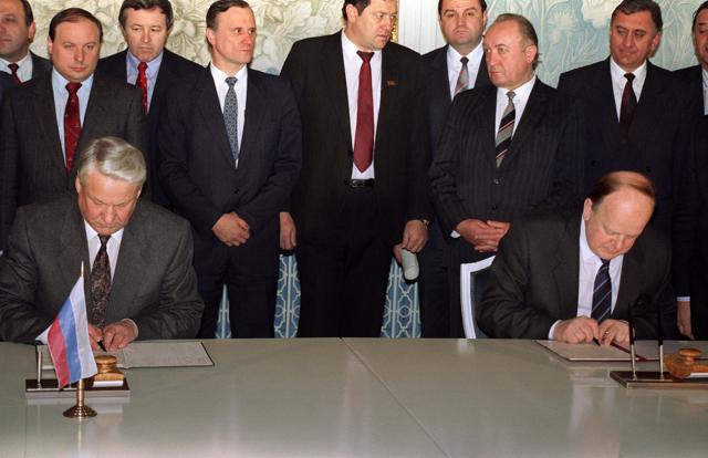 In this file photo taken on December 8, 1991, Russian President Boris Yeltsin (L) and Belarus' Supreme Soviet Chairman Stanislav Shushkevich (R) sign a document stating that "the Soviet Union as a geopolitical reality [and] a subject of international law has ceased to exist." (David Brauchli/AFP)